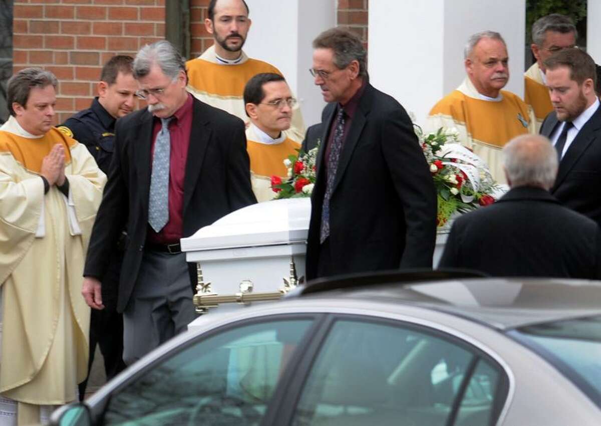 Pallbearers bring the casket of James Mattioli, 6, of Newtown to the hearse during his funeral at the St. Rose of Lima Roman Catholic church Tuesday morning, December 18, 2012. Mattioli was killed by a gunman who also claimed the lives of 6 adults and 19 other children at the Sandy Hooky Elementary School shooting Friday, December 15, 2012. Photo by Peter Hvizdak / New Haven Register
