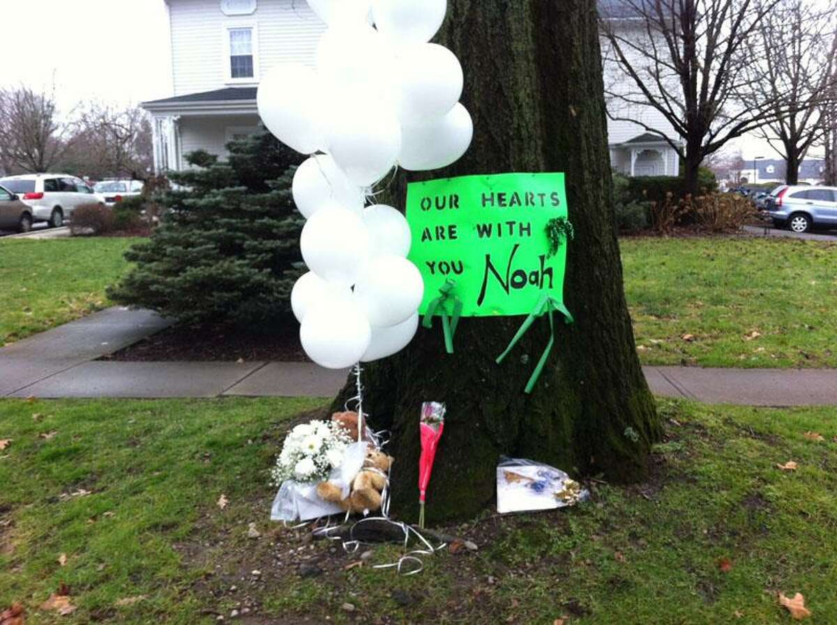A sign for Newtown shooting victim Noah Pozner, 6, reads "Our hearts are with you Noah" in Fairfield Monday. Peter Casolino/New Haven Register