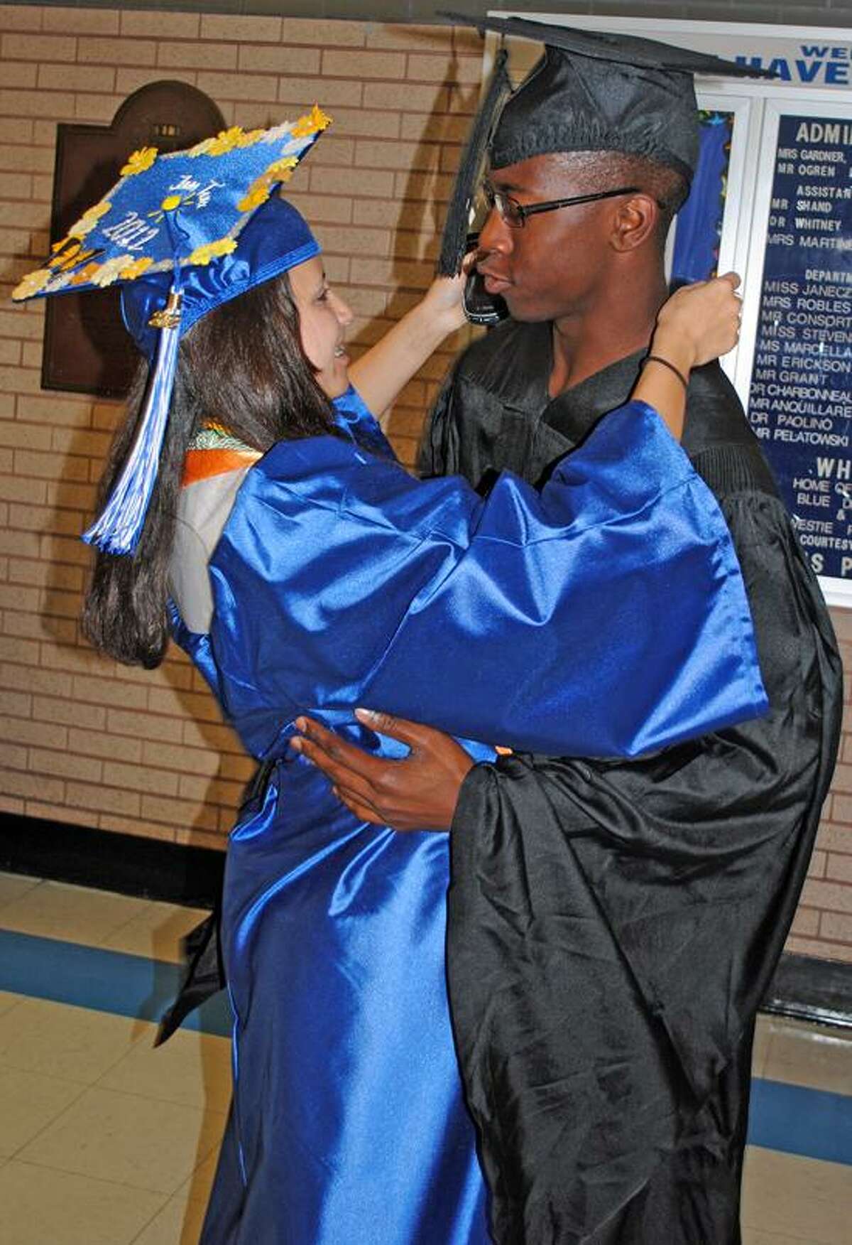 Jessica Teixeira, left, giving Abdul Zachariah, a student representative on the Board of Education, a hug on the day of their graduation. Photo by Jen Fengler/New Haven Register