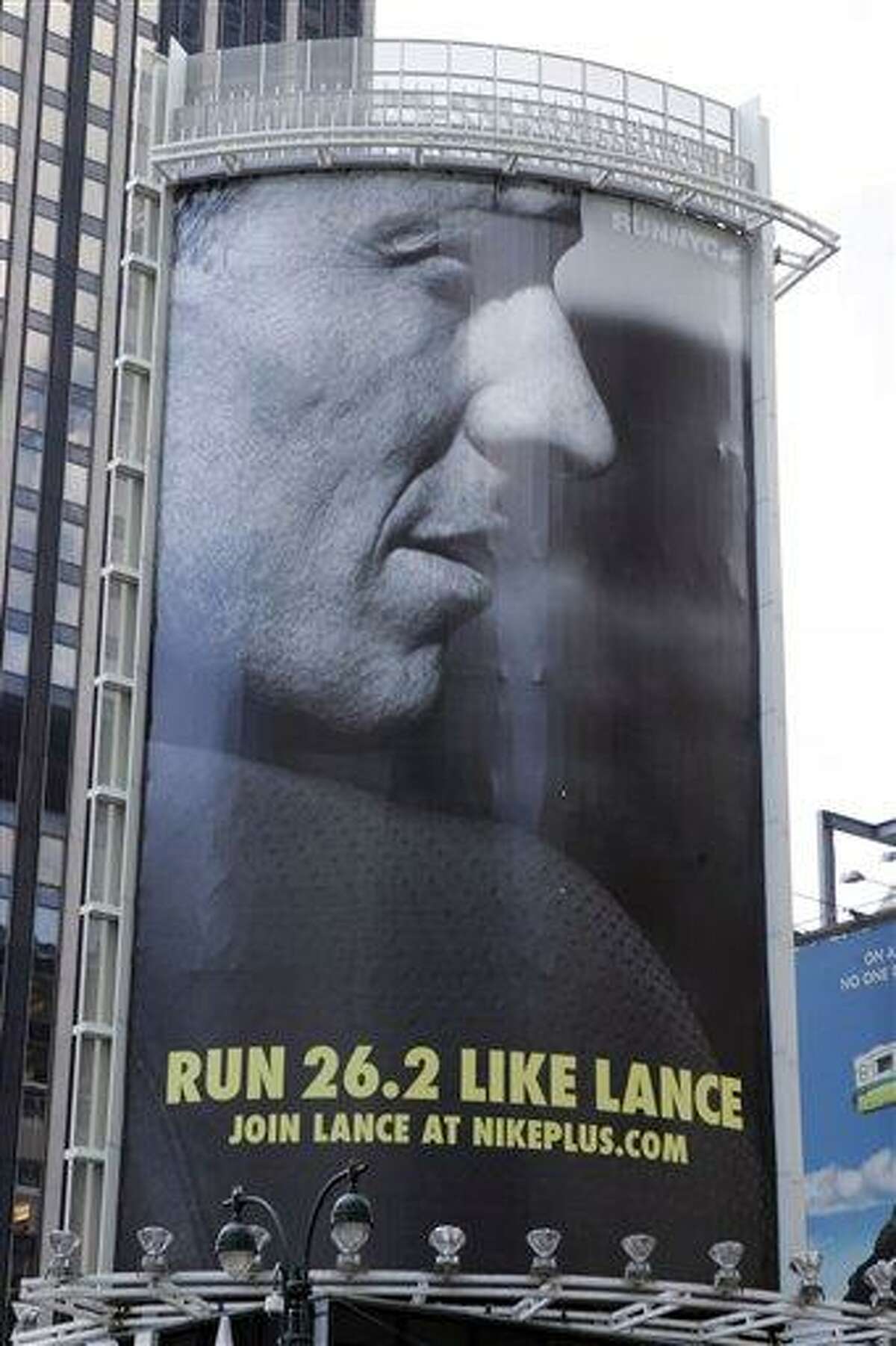 In an 80-foot billboard at 34th Street and 7th Avenue in Manhattan, Lance Armstrong and Nike challenge New Yorkers to "Run Like Lance" in a 2006 file photo. Nike said Wednesday that it is severing ties with Armstrong, citing insurmountable evidence that the cyclist participated in doping and misled the company for more than a decade. Associated Press