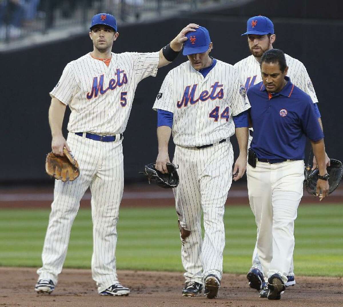 ASSOCIATED PRESS New York Mets third baseman David Wright (5) gives encouragement to teammate Jason Bay (44) as Bay is helped off the field after being injured on a play during the second inning of Friday's game against the Cincinnati Reds in New York.