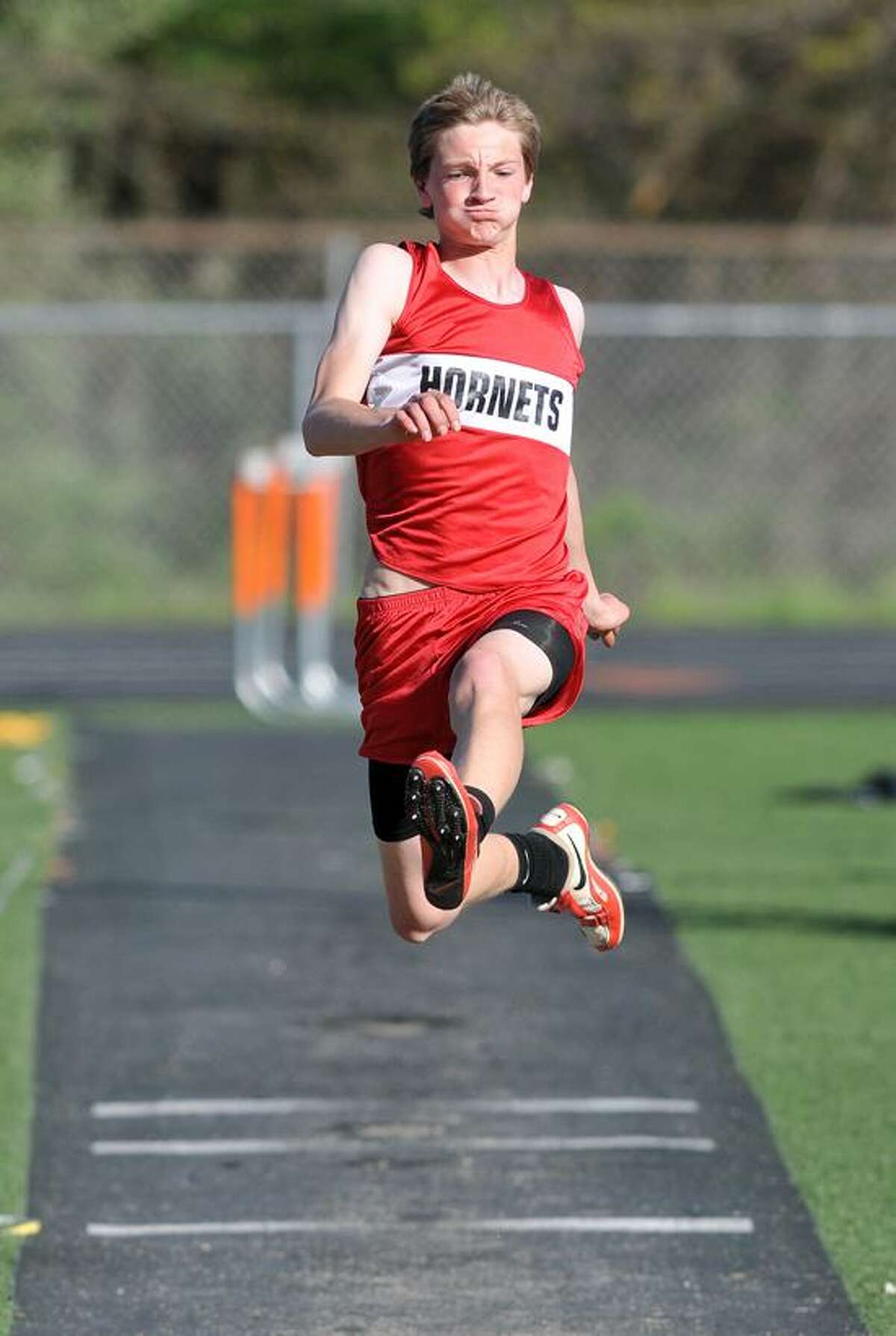 Branford's Jared Kech jumps 18 feet, 3 inches to win the long jump. Peter Casolino/New Haven Register