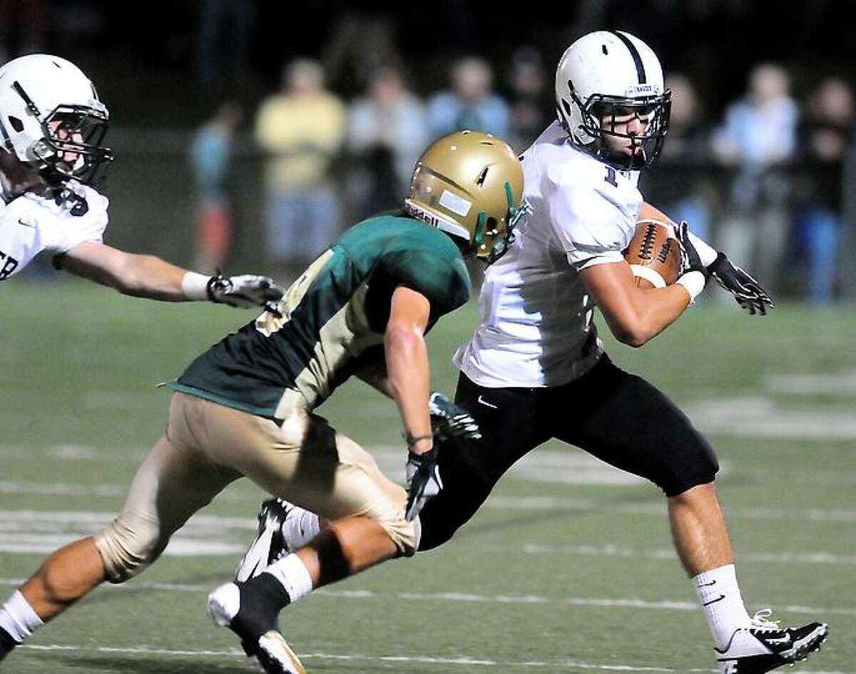 Christopher Perry (center) of Notre Dame of West Haven pursues Andrew Meoli (right) of Xavier runs in the second half in West Haven on 9/14/2012.Photo by Arnold Gold/New Haven Register