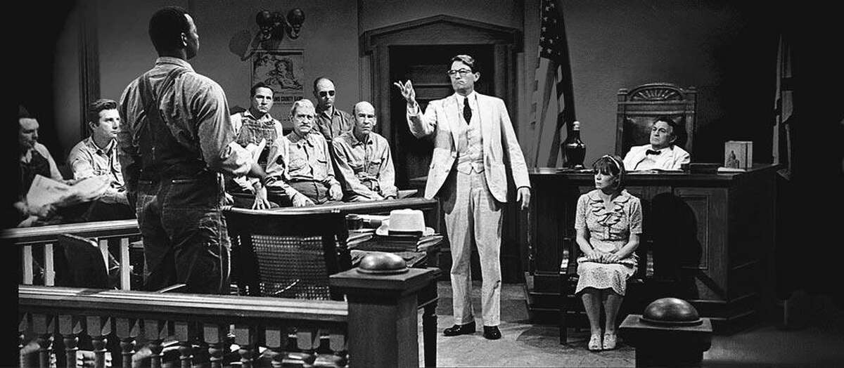 "Defense lawyer Atticus Finch (Gregory Peck), center, defends Tom Robinson (Brock Peters), left, against the false rape accusation of Mayella Ewell (Collin Wilcox), right." (NBC Universal)