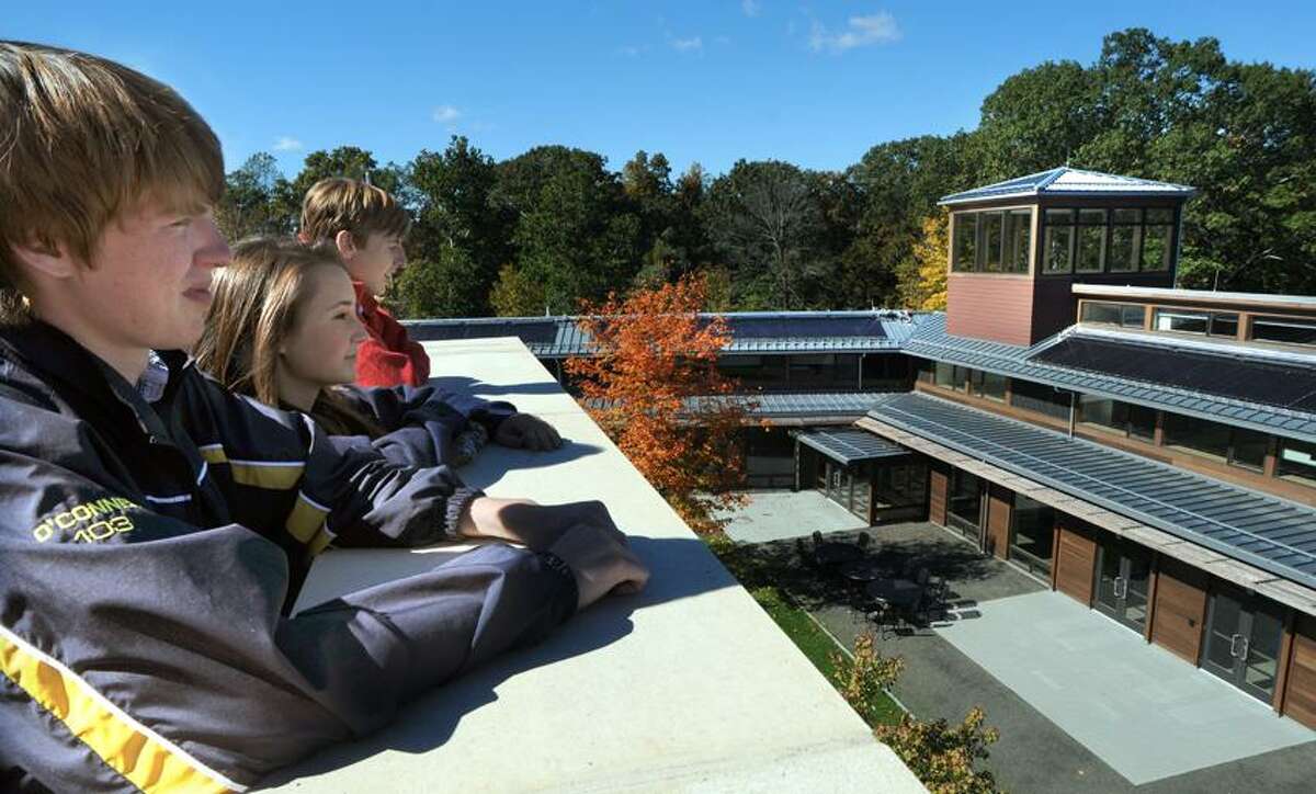 Choate Rosemary Hall in Wallingford students Riley O'Connell of Wallingford left, Courtney Pal of New Canaan, and Zachary Berzolla of Old Greenwich , right, look over the courtyard at the school's Kohler Environmental Center where they attend classes and live for a year. Mara Lavitt/New Haven Register