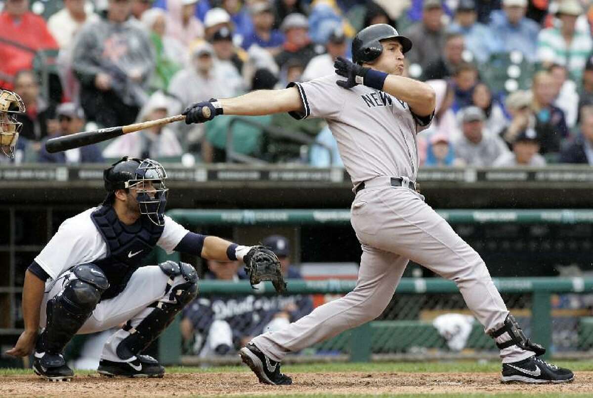 ASSOCIATED PRESS New York Yankees' Mark Teixeira hits a solo home run as Detroit Tigers catcher Alex Avila, left, watches in the eighth inning of Thursday's game in Detroit. The Yankees won 4-3.