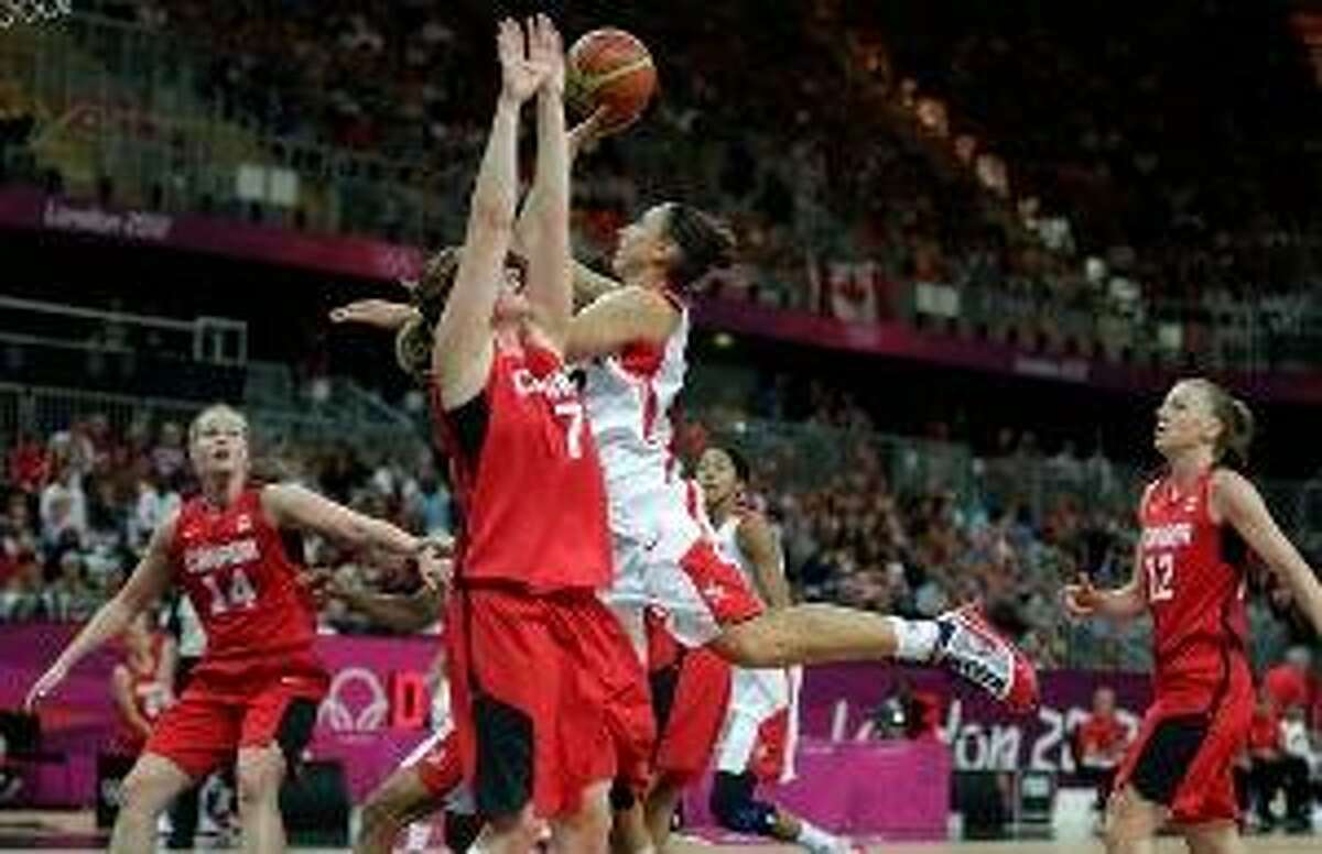 ASSOCIATED PRESS USA's Diana Taurasi drives to the basket against Canada's Courtnay Pilypaitis during a women's basketball game at the 2012 Summer Olympics Tuesday in London.