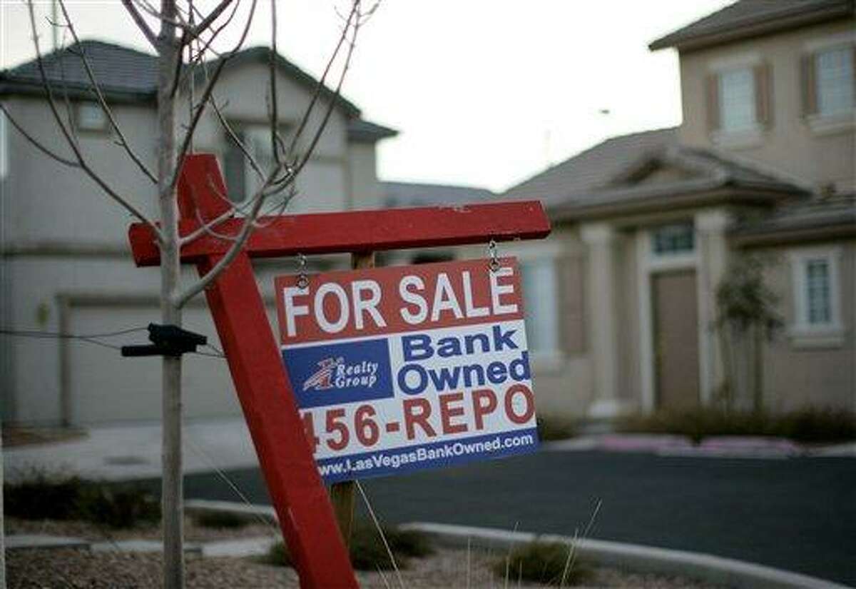 In this 2008 file photo, a for sale sign stands in front of a bank-owned home in Las Vegas. More U.S. homes are entering the foreclosure process, setting the stage for a surge in properties repossessed by lenders in 2012. Thirty-one states posted a monthly increase in homes with a first-time foreclosure notice according to Realty Trac Thursday. Nevada led the pack with an increase of 153 percent. Associated Press