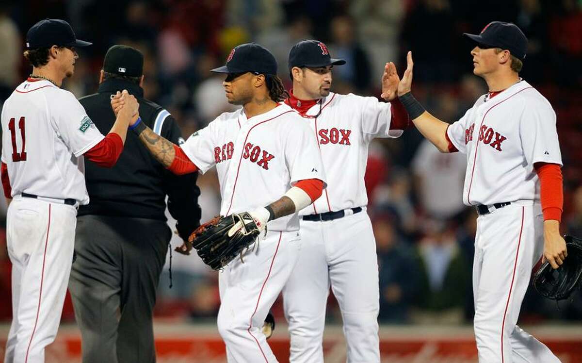 Boston Red Sox's Clay Buchholz, left, celebrates with teammates, from second from left, Darnell McDonald, Adrian Gonzalez and Ryan Sweeney after the Red Sox defeated the Baltimore Orioles 7-0 in a baseball game Thursday, June 7, 2012, in Boston. Buchholz threw a four-hitter. (AP Photo/Michael Dwyer)