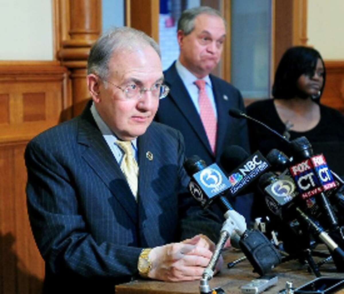 State Senate Majority Leader Martin Looney, left, answers questions concerning the repeal of the death penalty legislation at a press conference at City Hall in New Haven. At center is New Haven Mayor John DeStefano Jr. and at right is Victoria Coward whose son, Tyler, was shot and killed in 2007. Arnold Gold/New Haven Register