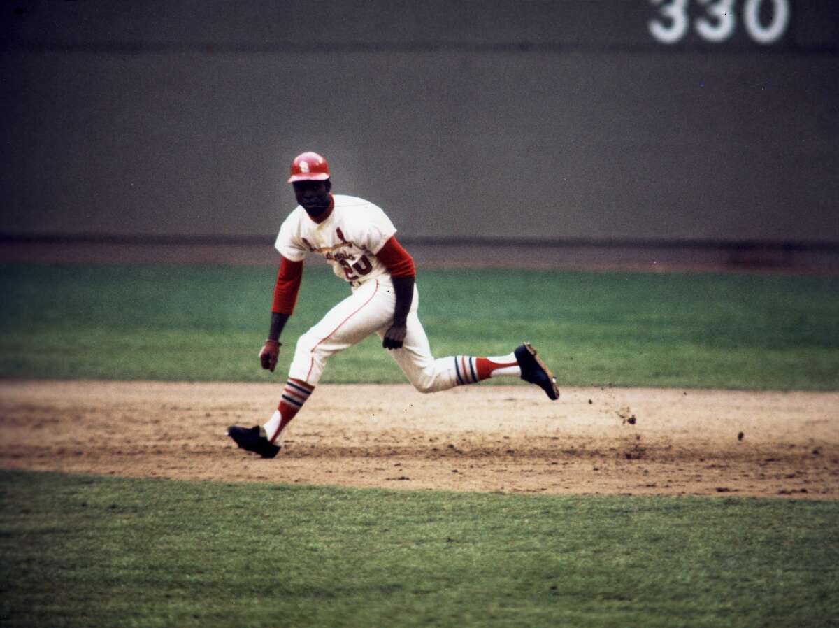 Outfielder Lou Brock of the St. Louis Cardinals with his lead from