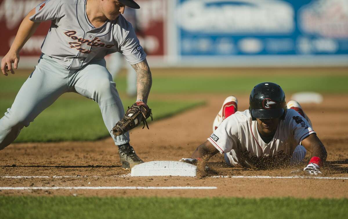 Loons right fielder Carlos Rincon slides back into first base as Bowling Green's Robbie Tenerowicz fails to tag him out during their game on Thursday, July 27, 2017 at Dow Diamond.