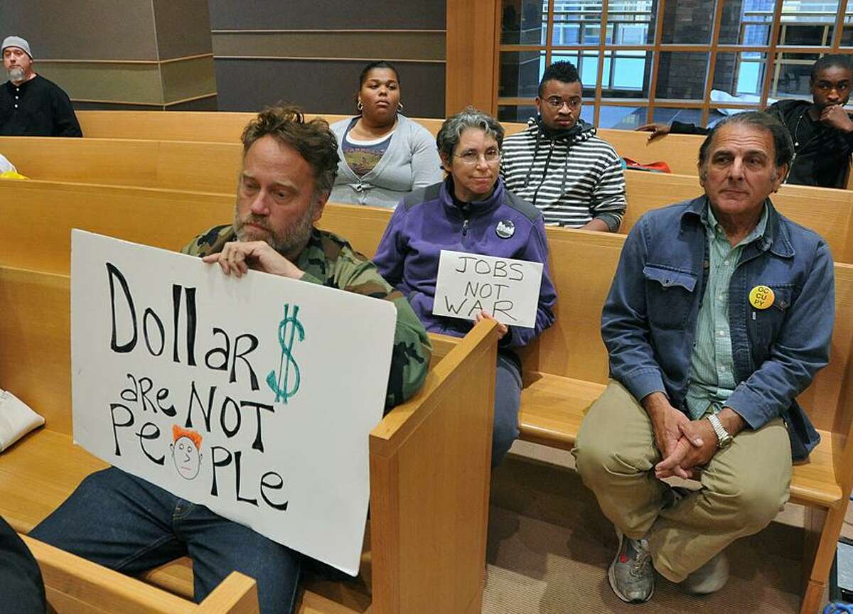 Protesters, including Ray Neal, front, attended the New Haven Board of Aldermen meeting at City Hall early Monday evening. Peter Casolino/New Haven Register