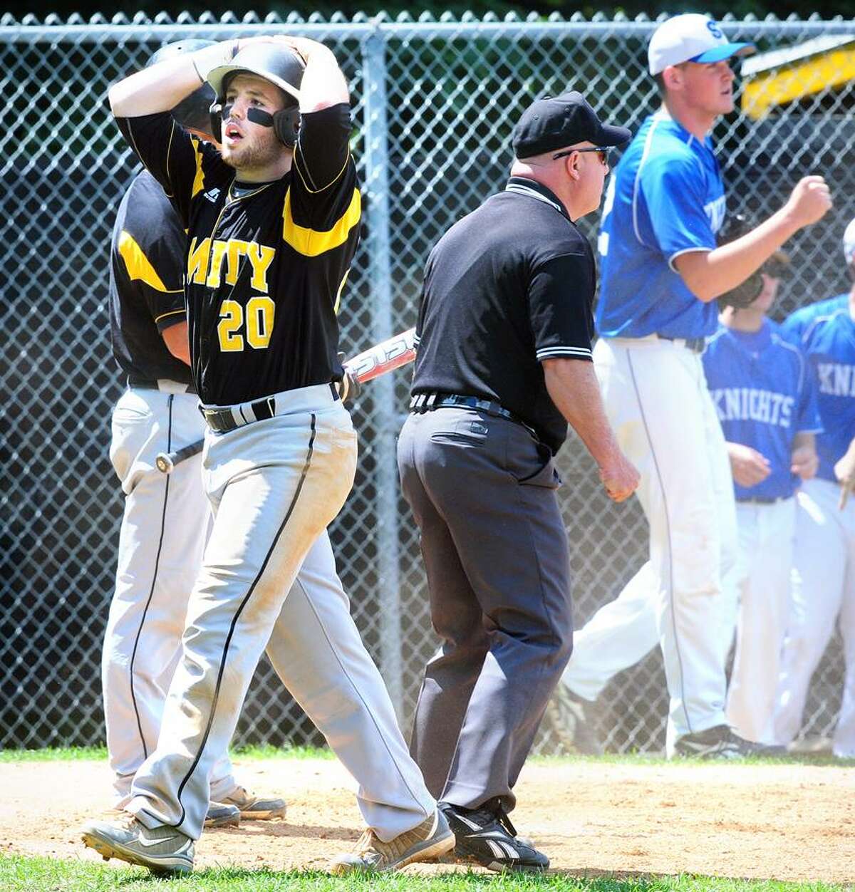 Paul Gusmano (left) of Amity reacts after being called out at the plate against Southington in the fourth inning on 6/3/2012. At right is Southington pitcher Justin Robarge.Photo by Arnold Gold/New Haven Register