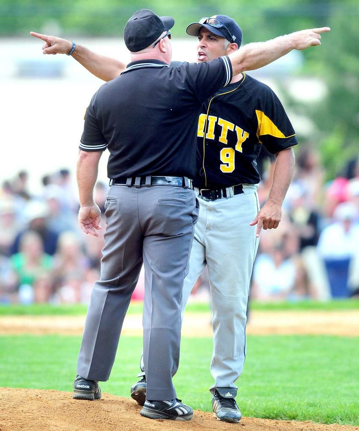 Amity coach Sal Coppola argues with an umpire over a call concerning an outfield fly ball in the sixth inning against Southington on 6/3/2012.Photo by Arnold Gold/New Haven Register