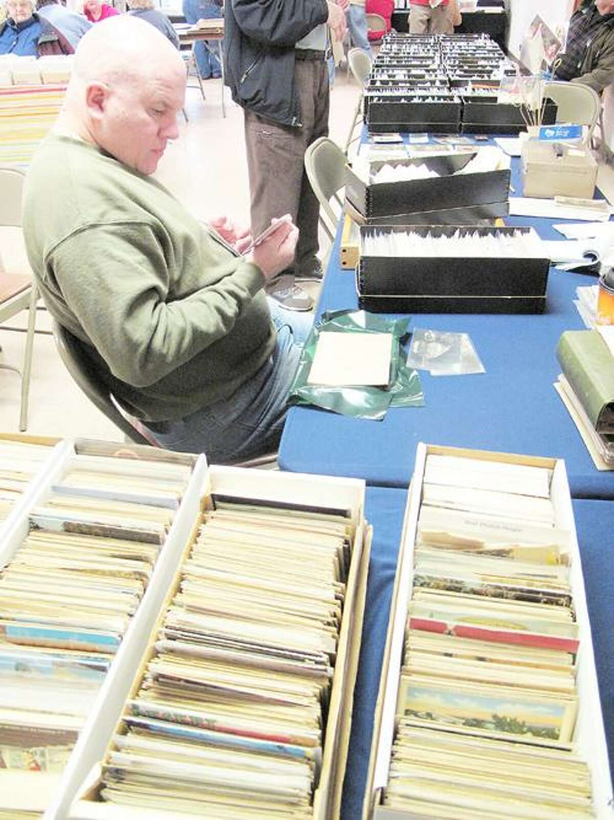 Photo by JOHN HAEGER (Twitter.com/OneidaPhoto) Tom Gates of Ava looks for postcards of the Adirondacks during the 28th annual spring Post Card Show and Sale at St. Paul's United Methodist Church on Saturday, March 31, 2012.