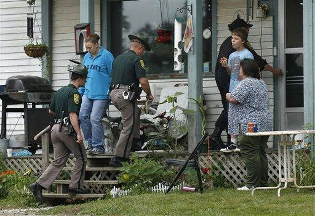New Hampshire State Police Troopers enter the family home of Celina Cass in Stewartstown, N.H., Wednesday, July 27, 2011. Cass, 11, has been reported missing since she was last seen at her home on Monday evening a few miles from the area they were searching.(AP Photo/Charles Krupa)