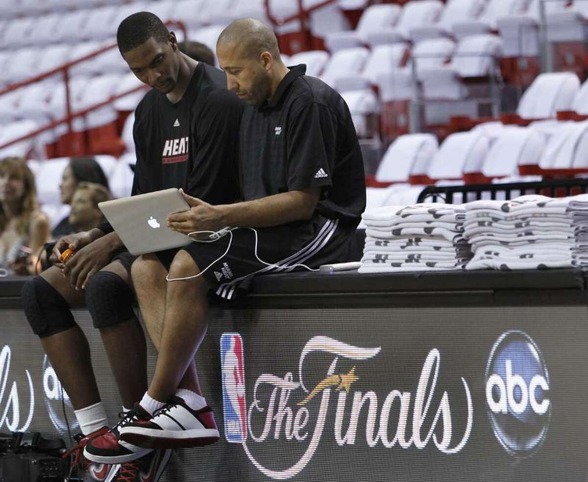 Miami Heat's Chris Bosh, left, talks with assistant coach David Fizdale during practice, Monday, May 30, 2011 in Miami. The Heat will play the Dallas Mavericks in Game 1 of the NBA basketball finals on Tuesday. (AP Photo/Wilfredo Lee)