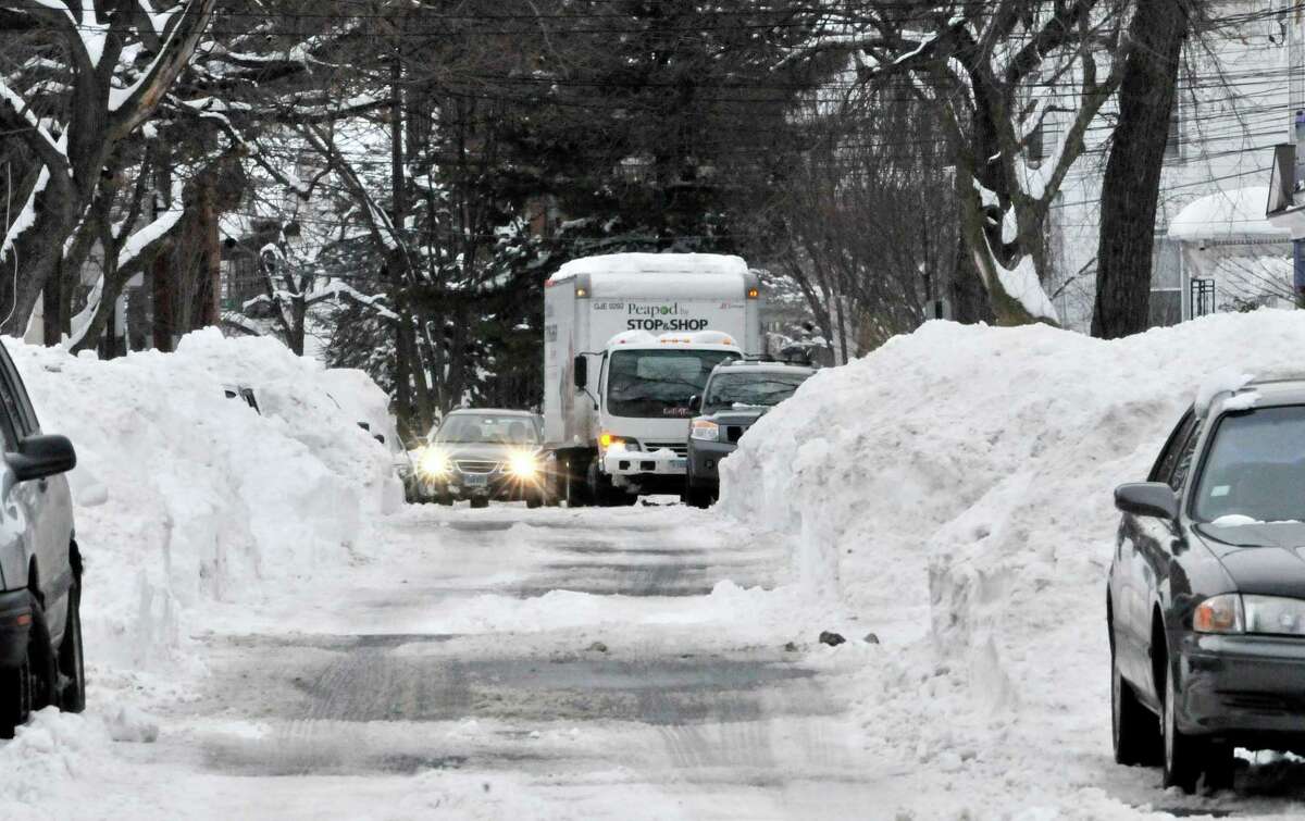 NEW HAVEN___A car waits, stuck, behind a STOP & SHOP delivery truck on Pearl Street. Melanie Stengel/Register1/29/11