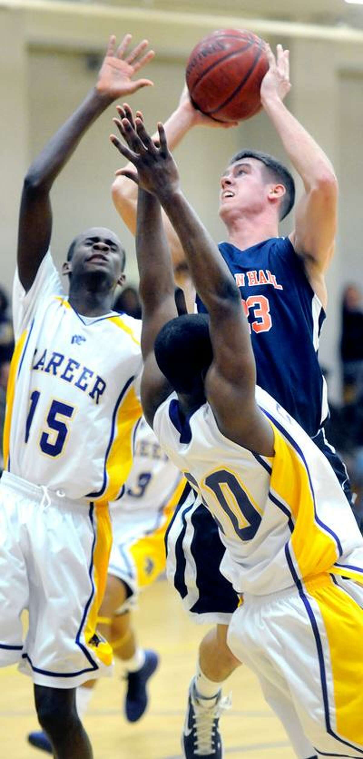 John DeSandre (right) of Lyman Hall takes a shot over Kenny Armstead (left) and Greg Johnson (bottom)of Career in the first half at Career High School in New Haven on 1/28/2011. Career won 57-55.Photo by Arnold Gold/New Haven Register AG0401C