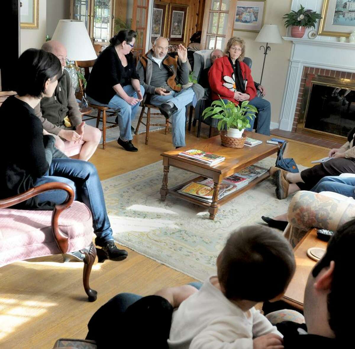 Residents who live in the Austen Road area discuss the bad behavior and public distrubances of some Quinnipiac University students living off campus and on and around their streets. Clockwise from bottom right are: Eliad Laskin with his daughter Maya Laskin, 1, Deb Flonc, John Moynihan, Lynn Mudry, David Kiljanowicz, Dick and Sherry Craft. Peter Hvizdak / Register November 19, 2011 ph2412 Connecticut