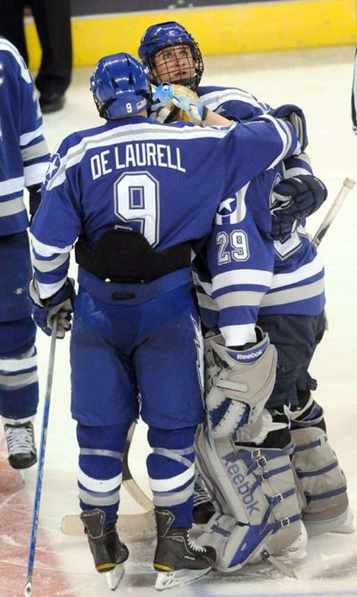 Air Force teammates Kyle DeLaurell, left, and Brad Sellers, center, console their goalie Jason Torf after Chad Ziegler of Yale scored the winning goal against goalie Jason Torf of Air Force Friday 3/25/11 during fourth period overtime action at the Arena at Harbor Yard in Bridgeport Connecticut at the 2011 NCAA Men's Ice Hockey East Regional. Photo by Peter Hvizdak / New Haven RegisterMarch 25, 2011 ph2282