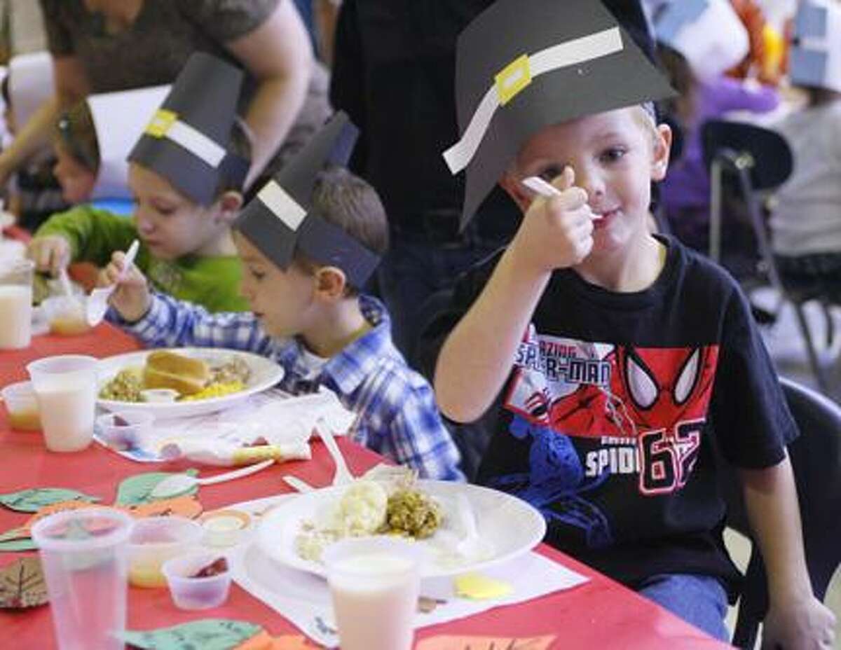 Dispatch Staff Photo by JOHN HAEGER (Twitter.com/OneidaPhoto) J.D. George Elementary School pre-k student Mark Dust, 4, eats a Thanksgiving dinner with his classmates at the school on Tuesday, Nov. 22, 2011 in Verona. Twenty-eight turkeys were cooked to feed the 456 students at the school.