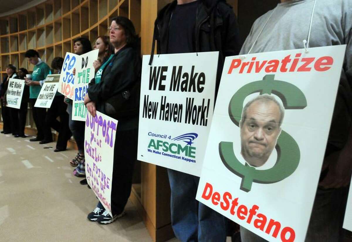 AFSCME union members protest at the back of Aldermanic chambers at New Haven City Hall before the Board of Alderman voted on the budget. (Mara Lavitt/Register)