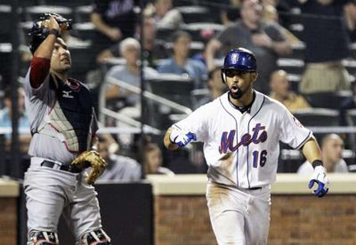 St. Louis Cardinals catcher Gerald Laird, left looks on as New York Mets' Angel Pagan reacts after hitting a walkoff home run to win a baseball game during the tenth inning on Wednesday, July 20, 2011, at Citi Field in New York. The Mets won the game 6-5. (AP Photo/Frank Franklin II)