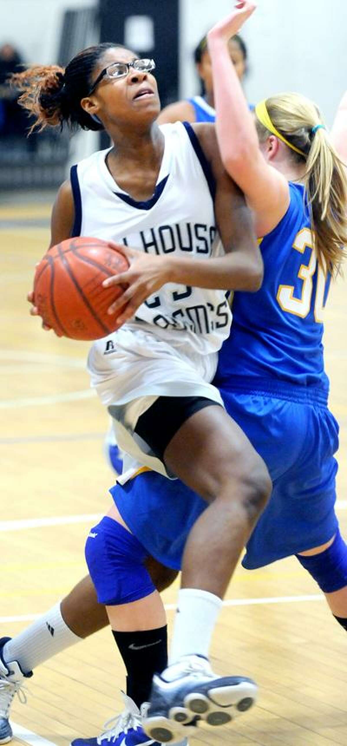 Bria Holmes (left) of Hillhouse drives through Cassie Santoro (right) of Mercy in the first half on 1/19/2011.Photo by Arnold Gold/New Haven Register AG0400B