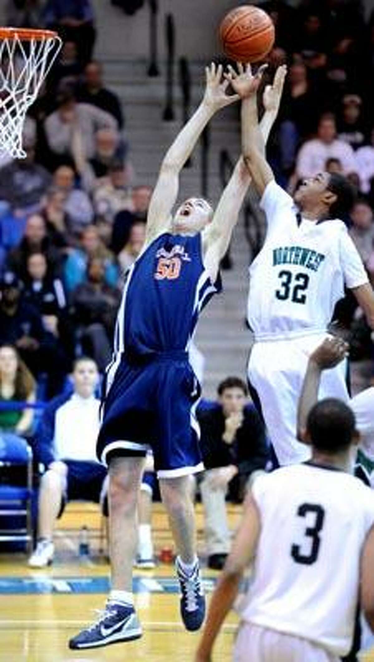 Jason Dempsey (left) of Lyman Hall and Tony Seldon (right) of Northwest Catholic go for a rebound in the second half of their Class L Semifinal game at Central Connecticut State University on 3/16/2011.Photo by Arnold Gold/New Haven Register AG0405E
