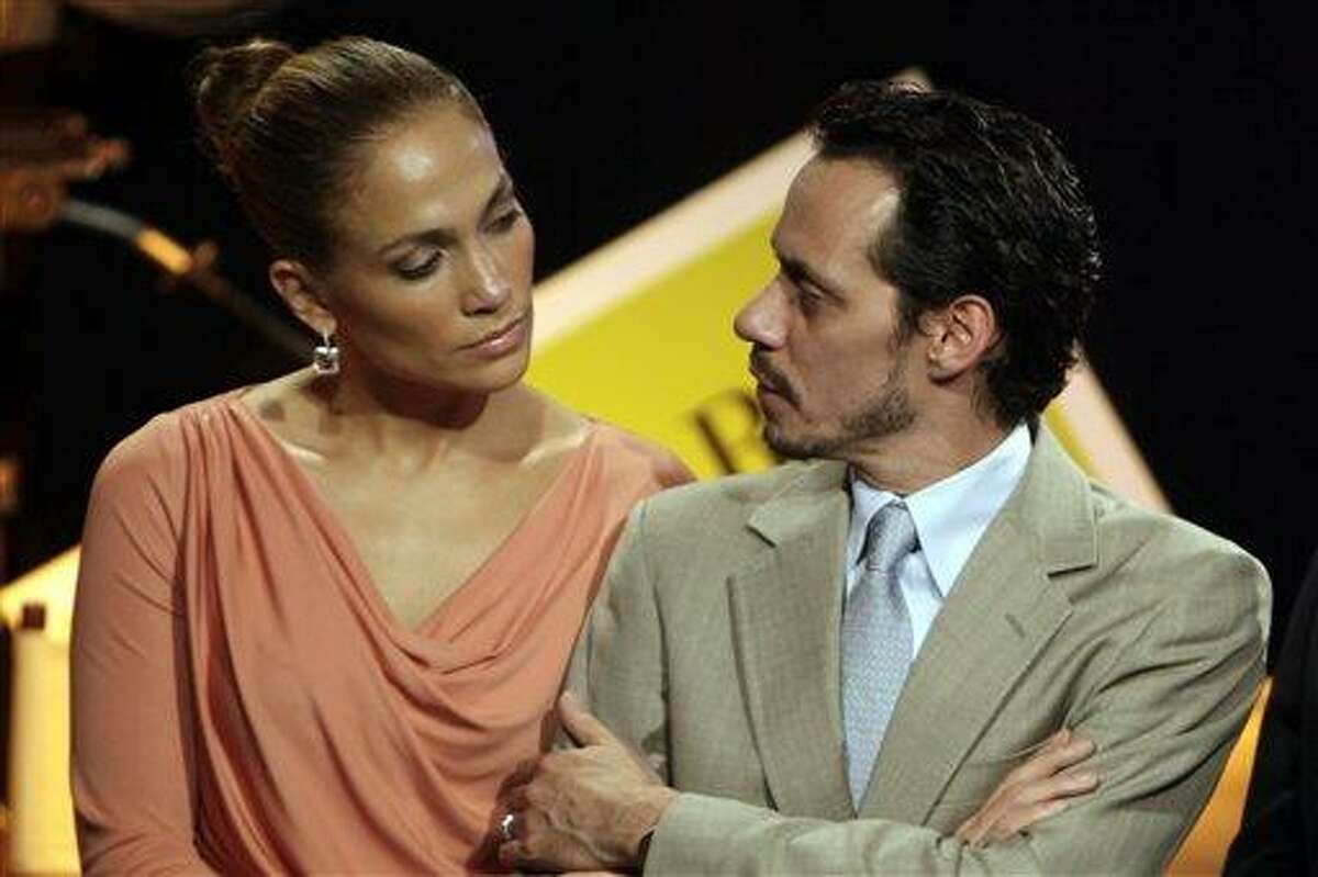 In this Friday March 4, 2011 picture, Jennifer Lopez, left, and husband Marc Anthony attend a signing ceremony for filmmaking incentive legislation for the U.S. island territory in Bayamon, Puerto Rico. The superstar couple announced Friday, July 15, 2011 they are breaking up. The two married in 2004 and have 3-year-old twins, Max and Emme. In a Friday statement from her publicist, the pair called the decision to end their marriage a "very difficult decision." They say they have come to an "amicable decision" on all matters and ask for privacy. It's Lopez's third marriage, Anthony's second. (AP Photo/Ricardo Arduengo)