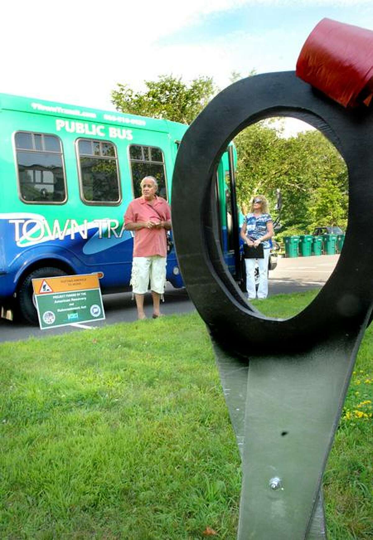Rich Cabral, Chairman of the Estuary Transit District, left, and vice chairman Leslie Strauss, of the district, speak at the presentation of the first hybrid electric minibuses of their size in New England. The ribbon-cutting took place at Old Lyme Town Hall. Melanie Stengel/Register