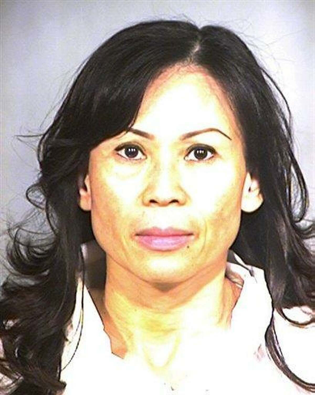 This undated handout photo provided by the Garden Grove Police Dept., shows a police booking photo of Catherine Kieu Becker, 48, who police say drugged her estranged husband, tied him to a bed, cut off his penis with a knife and threw it down a garbage disposal in her home in Garden Grove, Calif. Becker is due in court Wednesday, July 13, 2011. (AP Photo/Garden Grove Police Dept.)