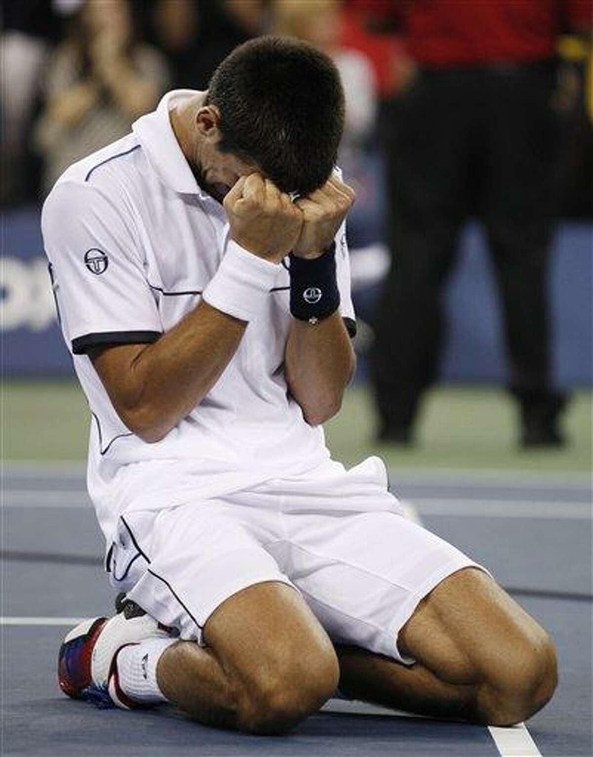 Novak Djokovic of Serbia reacts after winning the men's championship match against Rafael Nadal of Spain at the U.S. Open tennis tournament in New York, Monday, Sept. 12, 2011. (AP Photo/Charles Krupa)