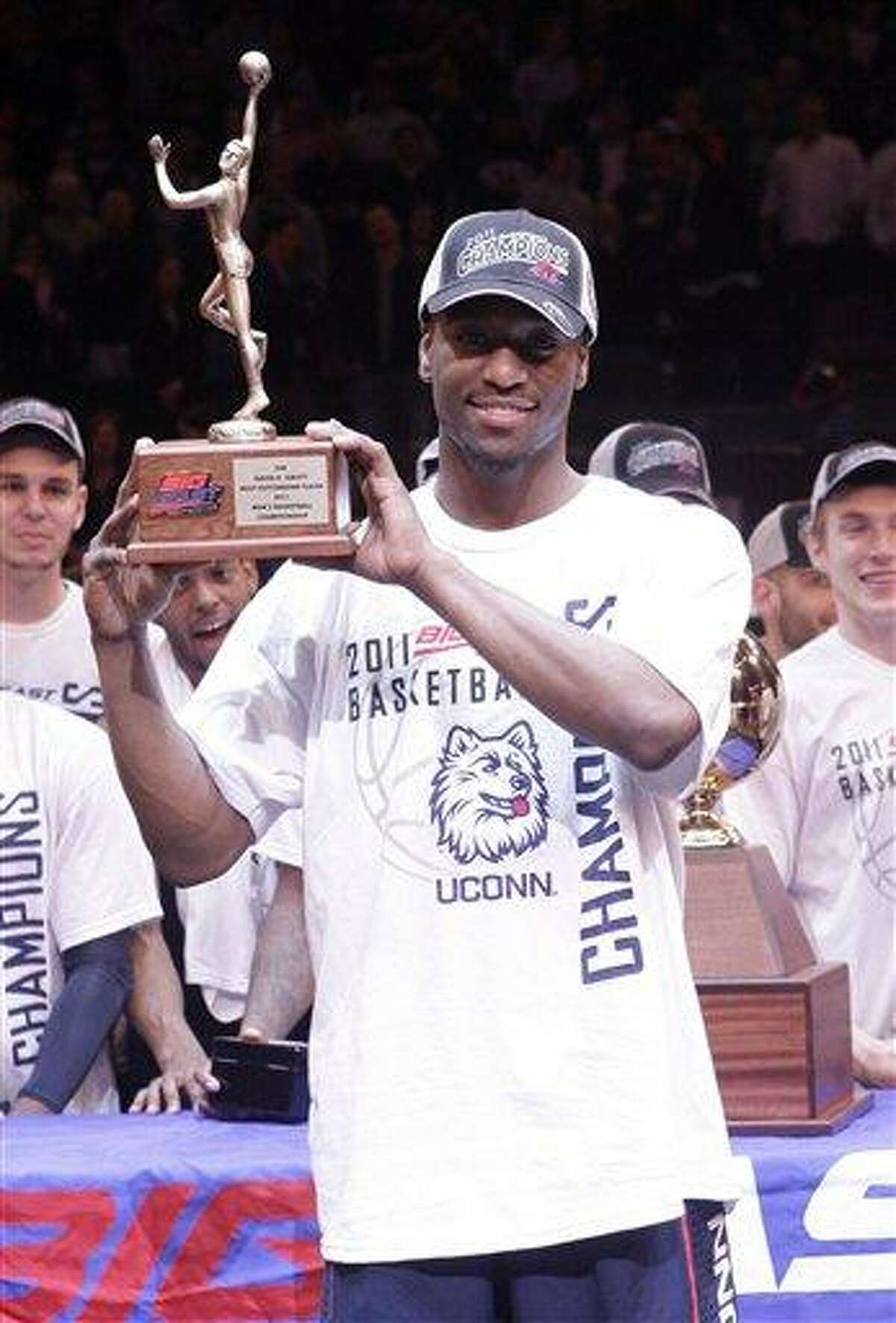 Connecticut's Kemba Walker (15) holds the Most Outstanding Player trophy after an NCAA college basketball game against Louisville at the Big East championship, Saturday, March 12, 2011, in New York. Connecticut won the game 69-66. Walker scored 19 points. (AP Photo/Frank Franklin II)