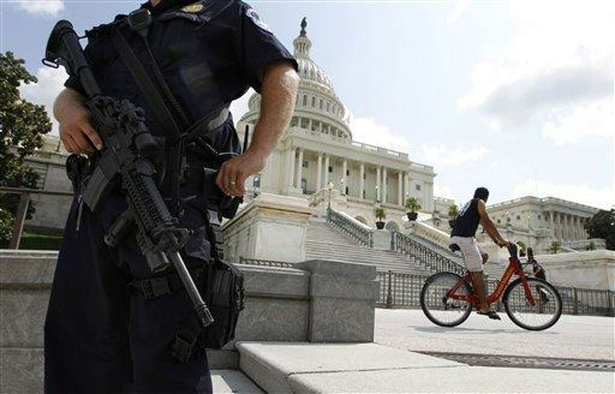 A U.S. Capitol Police officer patrols guards the grounds near the U.S. Capitol in Washington Saturday, Sept. 10, 2011, ahead of the 10th anniversary Sunday of the Sept. 11 attacks. (AP Photo/Jose Luis Magana)