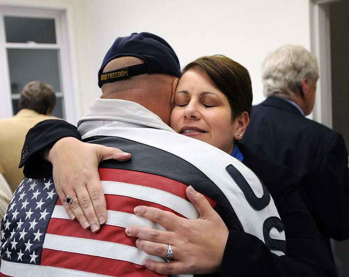 East Haven-- East Haven Mayor April Capone gets a hug from supporter, Bob Nappe, after Capone lost the election to Joe Maturo by 30 votes. Nappe is an East Haven police officer. Peter Casolino/New Haven Register11/08/11