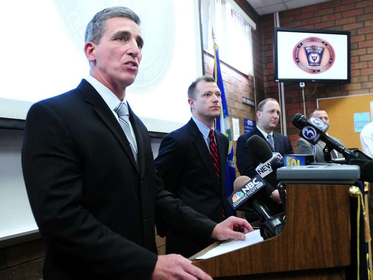 Milford Police Chief Keith Mello (left) and State's Attorney Kevin Lawlor (center) announce an arrest warrant was obtained for Luis Antonio Rodriguez on 1/14/2001 for the 2001 murder of Kelsey Mohahan of Milford.Photo by Arnold Gold/New Haven Register AG0399D