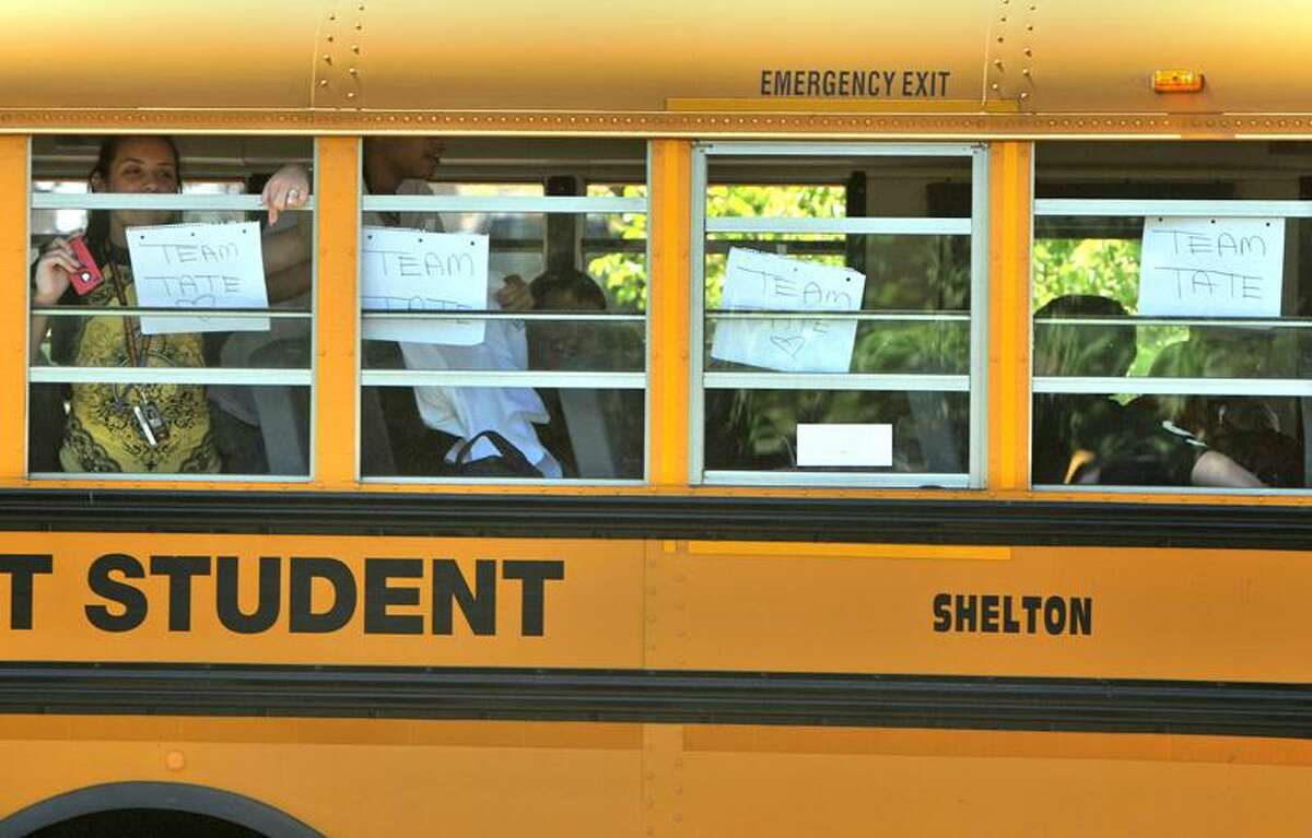 Supporters of James Tate leave school by bus Thursday afternoon in Shelton. Brad Horrigan/Register