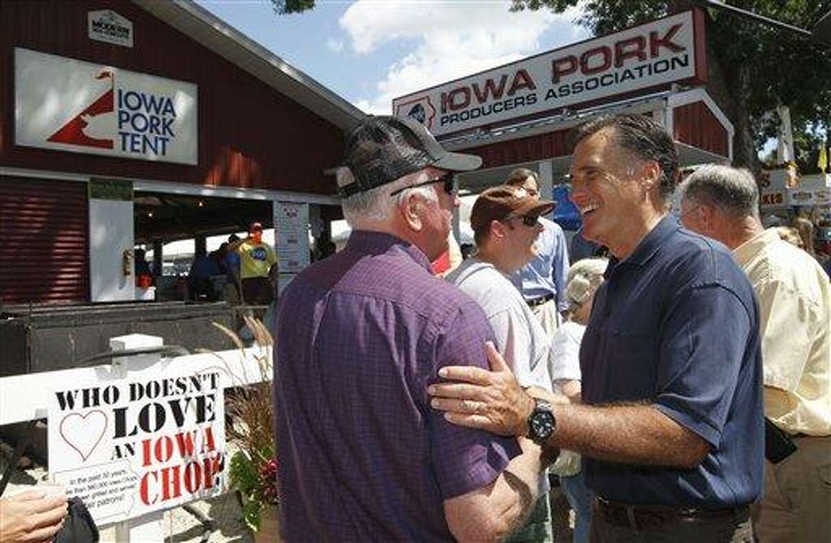 FILE - In this Aug. 11, 2011, file photo Republican presidential hopeful former Massachusetts Gov. Mitt Romney campaigns at the Iowa State Fair in Des Moines, Iowa. Romney and the other candidates are plenty serious about seeing and being seen at popular campaign stops in the early voting states of Iowa, New Hampshire and South Carolina. (AP Photo/Charles Dharapak, File)