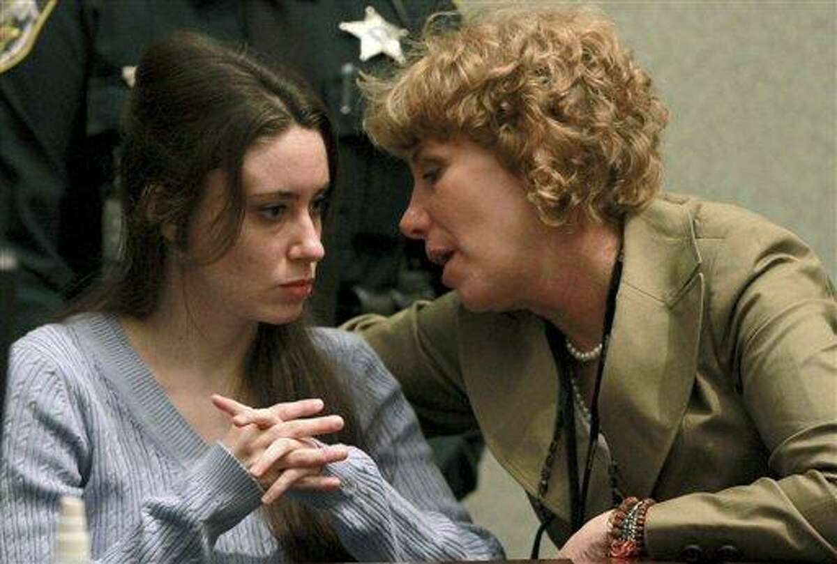 Casey Anthony, left, talks with her attorney, Dorothy Clay Sims, during a sentencing hearing in Orlando, Fla. on Thursday, July 7, 2011. Judge Belvin Perry sentenced Anthony to four years for lying to investigators but says she can go free in late July or early August because she has already served nearly three years in jail and has had good behavior. While acquitted of killing and abusing her 2-year-old daughter Caylee, Anthony was convicted of four counts of lying to detectives trying to find her daughter in July 2008. (AP Photo/Joe Burbank, Pool)
