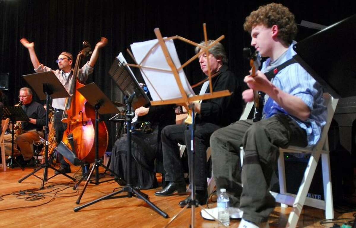 Local musicians perform for members of Congregation Mishkan Israel under the direction of David Chevan (far left) during the Annual Family and Community Concert of Jewish Music at the synagogue in Hamden on 12/25/2011. At right is Jonathan Zabin of Woodbridge and his son, Seth (far right), 17. Photo by Arnold Gold/New Haven Register