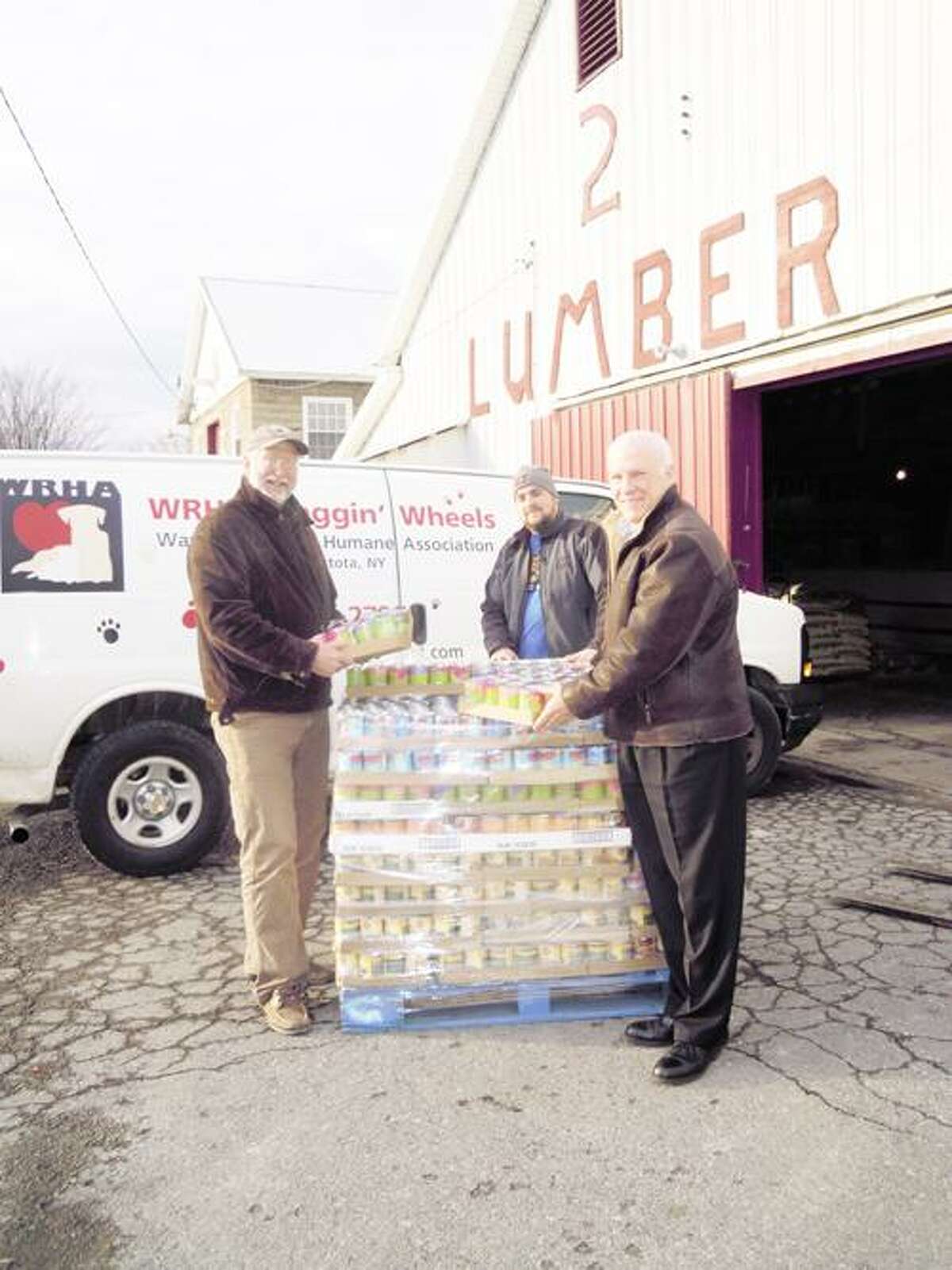 Photo Courtesy WANDERERS' REST From left are Glenn H. Ivers, executive director Wanderers' Rest Humane Association, Patrick Kime, and Doug Tudman, director sales and marketing at Isadore A. Rapasadi & Sons. Rapasadi transported the pallets from the Del Monte warehouse in Pennsylvania to Canastota. Kime's hardware store in Canastota is warehousing the pallets and helping to load them for the different organizations as they arrive to receive their pallet.
