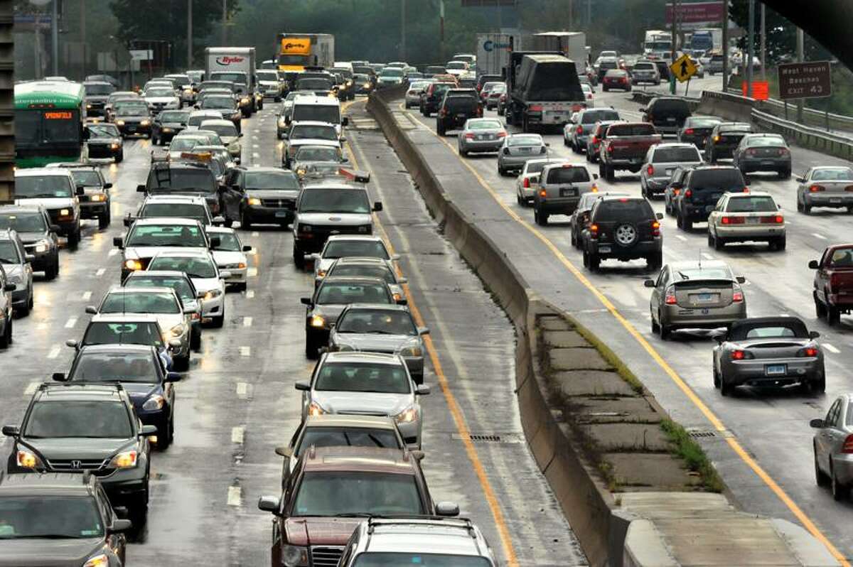 Traffic on Interstate 95 at Exit 44 facing south was heavy Thursday afternoon, but less cars are expected to be traveling for the Labor Day holiday. (Melanie Stengel/Register)