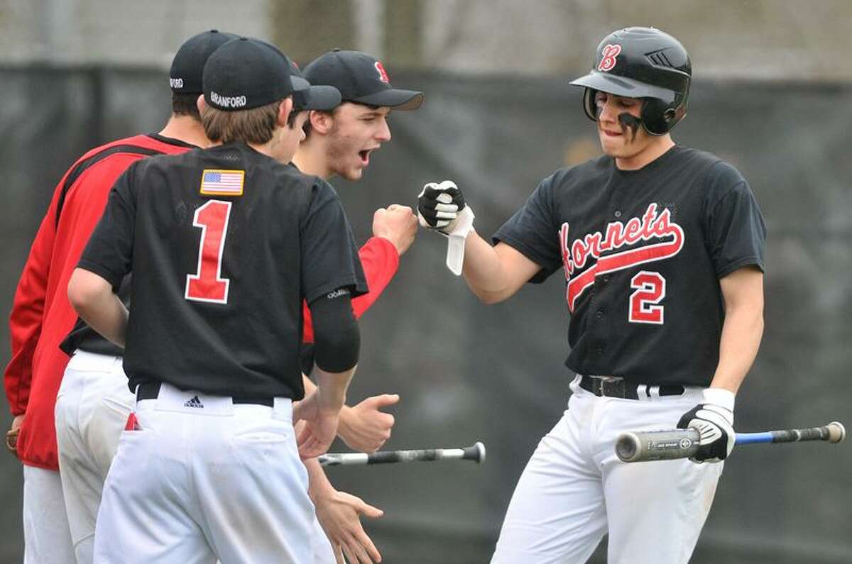 Branford's Buddy Shea is greeted by teammates after crossing home plate in Wednesday's win over North Haven. Photo by Brad Horrigan/New Haven Register