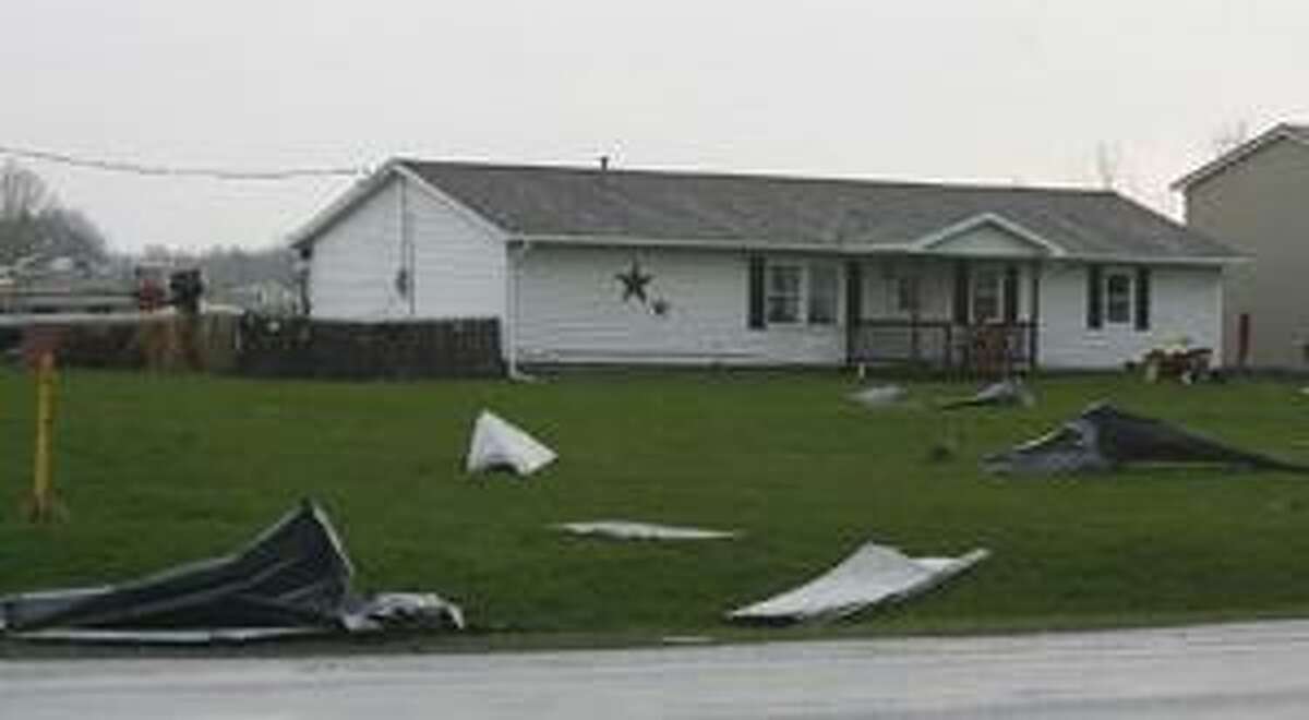 Photo by JOHN HAEGER Part of a roof lies on a lawn in the Town of Lenox after a storm Tuesday, April 26, 2011.