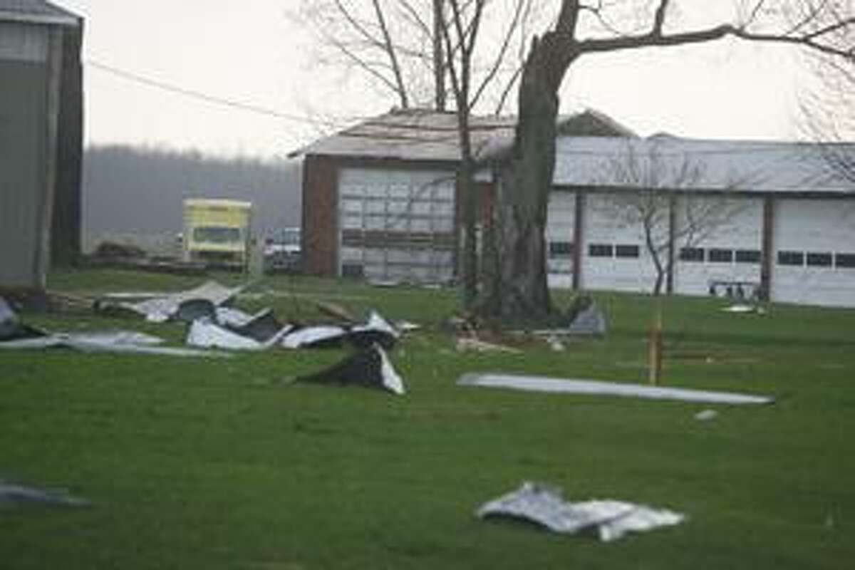 Photo by JOHN HAEGER Part of a roof lies on a lawn along Route 31 and Stephens Road in Lenox.