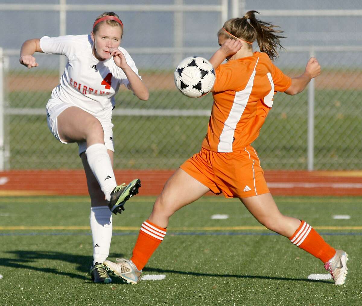 Dispatch Staff Photo by JOHN HAEGER twitter.com/oneidaphoto New Hartford's Lexie Raynard (4) crosses the ball into the center of the field as Oneida's Emily LaSalle (6) defends in the first half of the Sec III prelim in New Hartford on Tuesday, Oct. 25, 2011.
