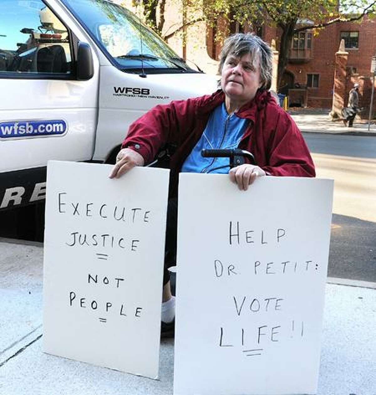 Anti-death penalty activist Clare Hogenauer of New York City holds signs outside Superior Court in New Haven Tuesday, the first day of the penalty phase of the Joshua Komisarjevsky murder trial. Peter Casolino/Register